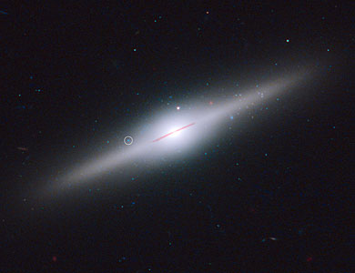 Star cluster surrounds wayward black hole in cannibal galaxy ESO 243-49 (labelled)