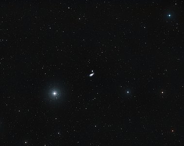 Distant view of a galactic crash — NGC 4490 and NGC 4485 (ground-based image)