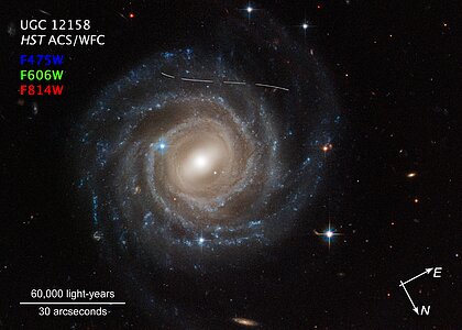Asteroid photobombs Hubble snapshot of Galaxy UGC 12158 (compass image)