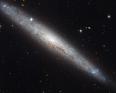 Hubble portrays a dusty spiral galaxy