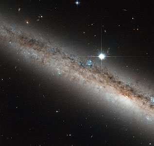 A spiral galaxy crowned by a star